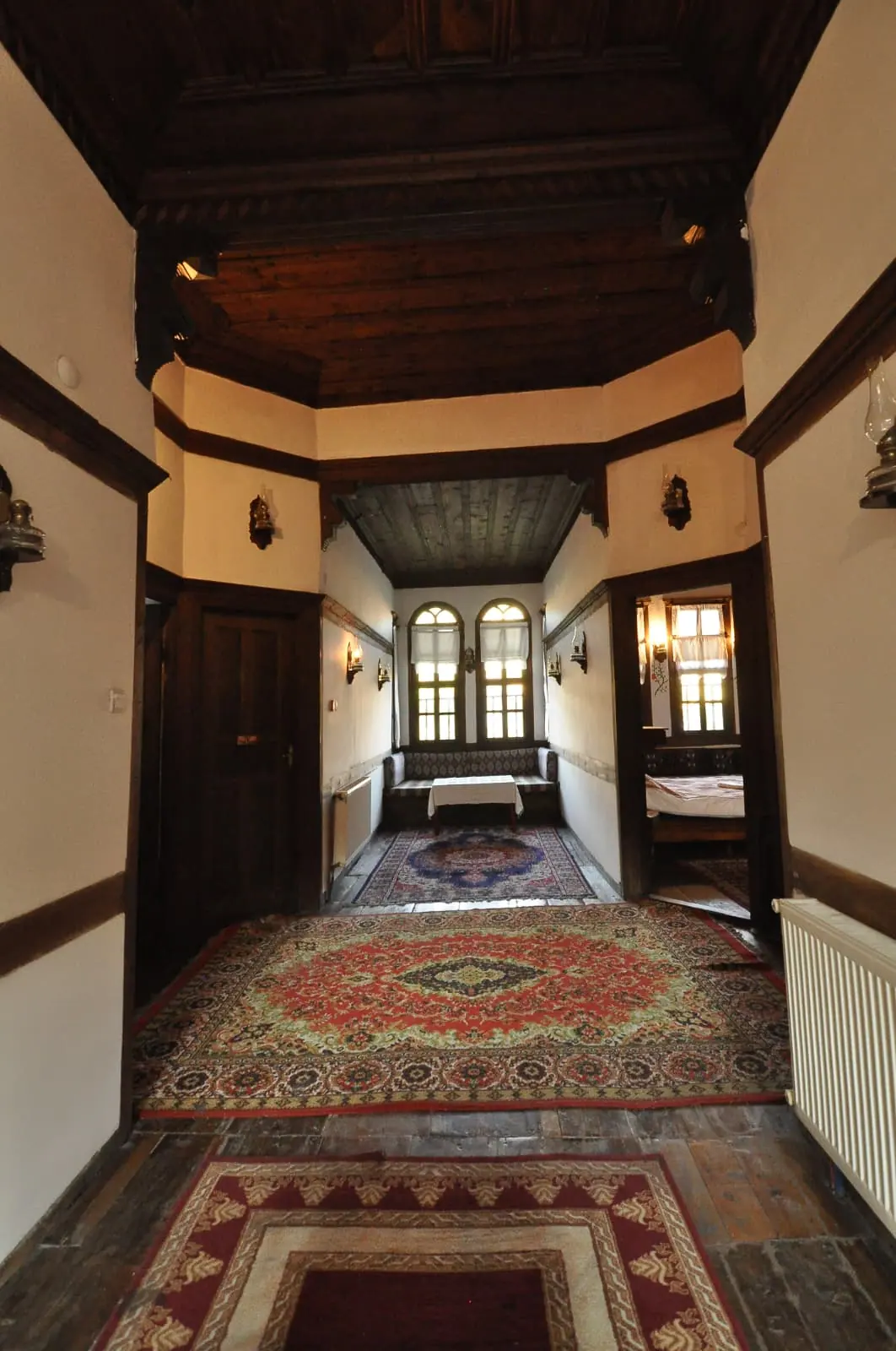 Interior corridor with a wooden ceiling and woven rugs