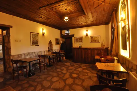 Wooden furniture and a stone floor in the shared lounge