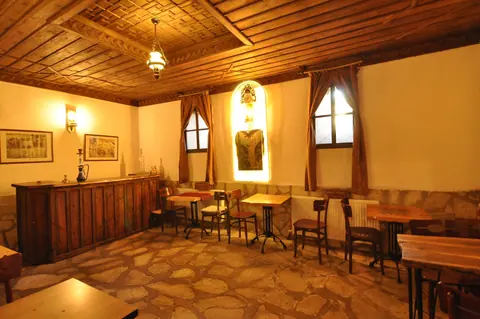 Another view of the shared sitting area beneath a wooden ceiling