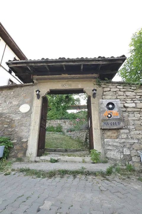 Garden entrance gate within a stone wall