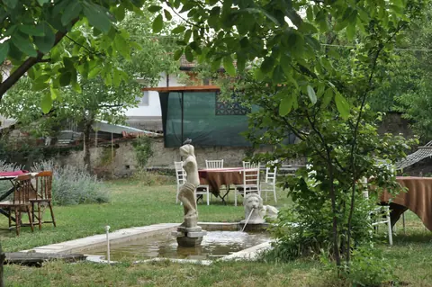 A corner of the garden surrounded by trees