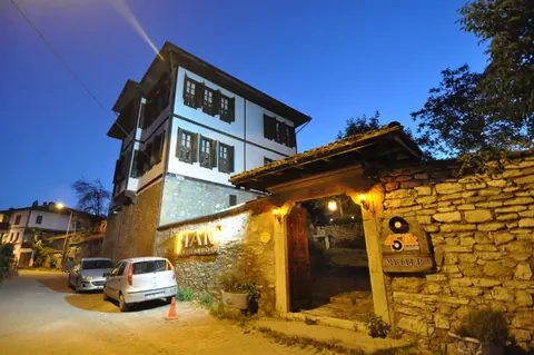 Side facade and stone wall in the evening